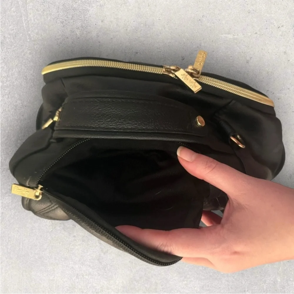 Itzy Ritzy Boss Plus black diaper bag backpack with gold hardware.
